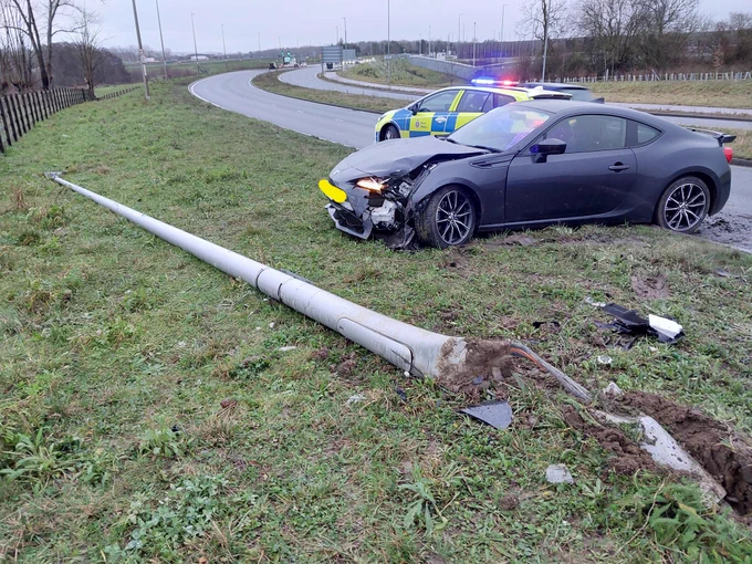 Police car, crashed car and damaged lamp post