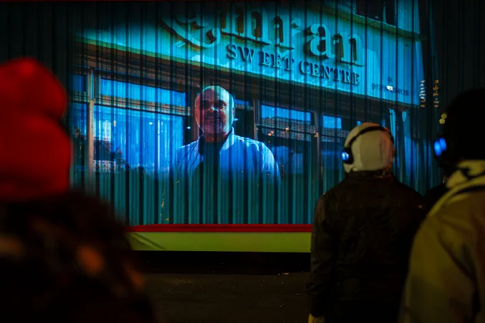 Projection of a film onto the front of a shop 