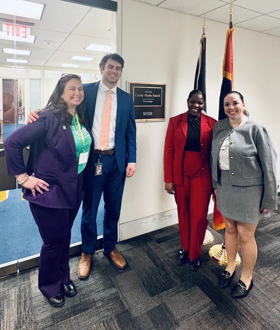 Four people standing by Senator Hyde-Smith’s office