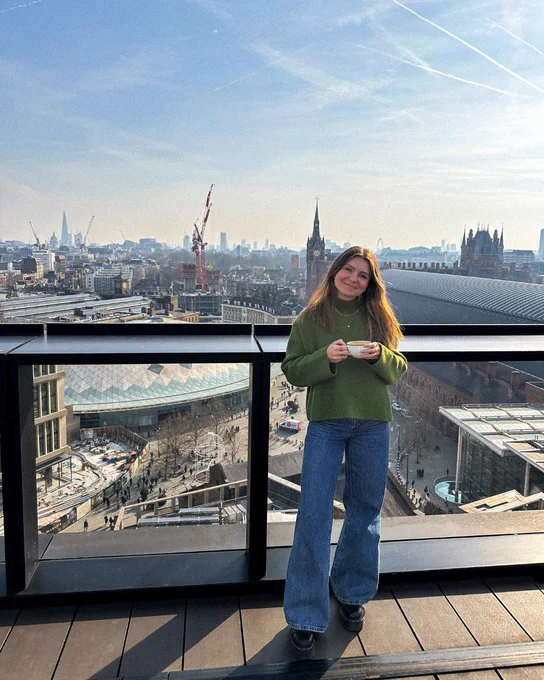 Teo posing on Google office rooftop, with view of London in the distance