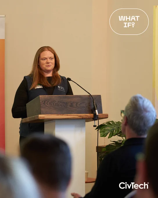 A representative of CivTech Challenge Sponsor National Trust for Scotland speaking in front of a podium.
