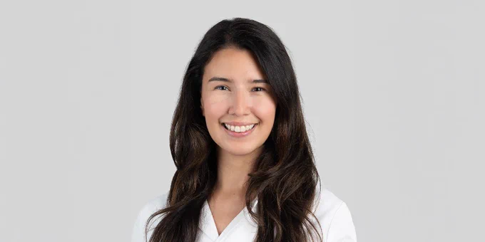 Portrait of Dr. Donna Kimmaliardjuk wearing a plain white top, smiling against a light grey background.