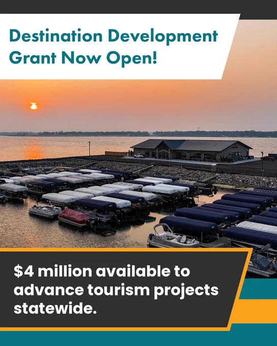 
Gemini said
An aerial view of a boat marina at sunset, featuring long rows of docked boats with blue and white covers. A modern building sits on the shoreline overlooking the water. Overlaid text reads, "Destination Development Grant Now Open! $4 million available to advance tourism projects"
