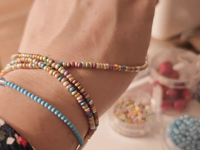 A necklace or bracelet. Colorful, small beads strung on string or thread.