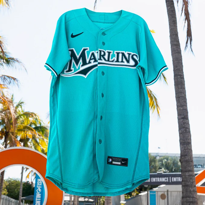 A teal Marlins uniform with black and white lettering being given away by MLB.