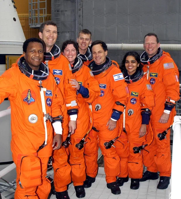 During Terminal Countdown Demonstration Test activities at the launch pad in December 2002, the STS-107 crew pauses for a group photo. From left are Payload Commander Michael Anderson, Commander Rick Husband, Mission Specialist Laurel Clark, Pilot William \"Willie\" McCool, and Mission Specialists Ilan Ramon, Kalpana Chawla and David Brown. Behind them is Space Shuttle Columbia. Coiumbia disintegrated during reentry on February 1, 2003, resulting in the deaths of all seven crew members.