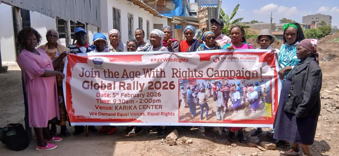 Photo shows a group of older people in Kenya outside next to a building holding up an Age With Rights Global Rally 2026 campaign banner.  