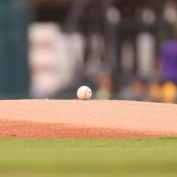 A baseball rests atop the pitcher's mound