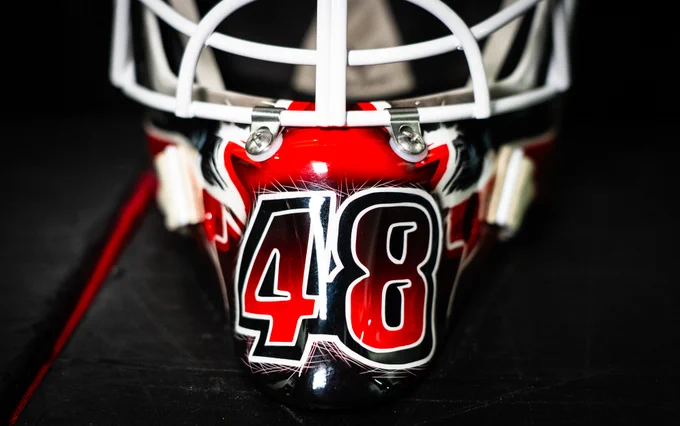 The front of LT's mask shows his number 48 in a red and black gradient.