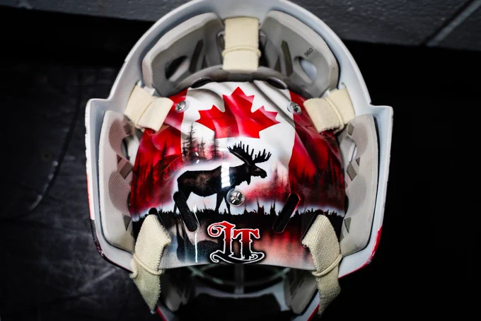 The backplate of Logan Thompson's Team Canada mask, featuring the Canadian flag, a moose and his initials, LT.