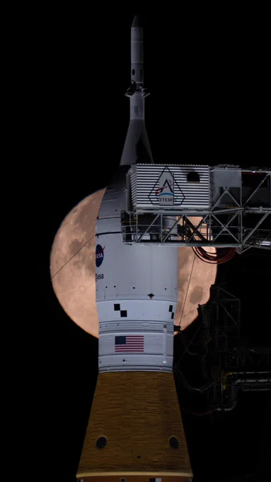 A full Moon is seen shining over NASA\u2019s SLS (Space Launch System) and Orion spacecraft, atop the mobile launcher in the early hours of Feb. 1, 2026. The rocket is currently at Launch Pad 39B at NASA\u2019s Kennedy Space Center in Florida, as teams are preparing for a wet dress rehearsal to practice timelines and procedures for the launch of Artemis II. The full Moon glows a pale orange color behind the white Orion spacecraft. The sky is black in the background. Credit: NASA/Brandon Hancock