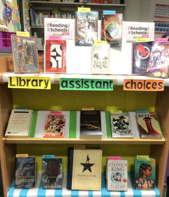 Library assistants choice display - photo shows this books display, with comics, fiction and non-fiction selected and post-its showing the names of pupils who have selected the titles.