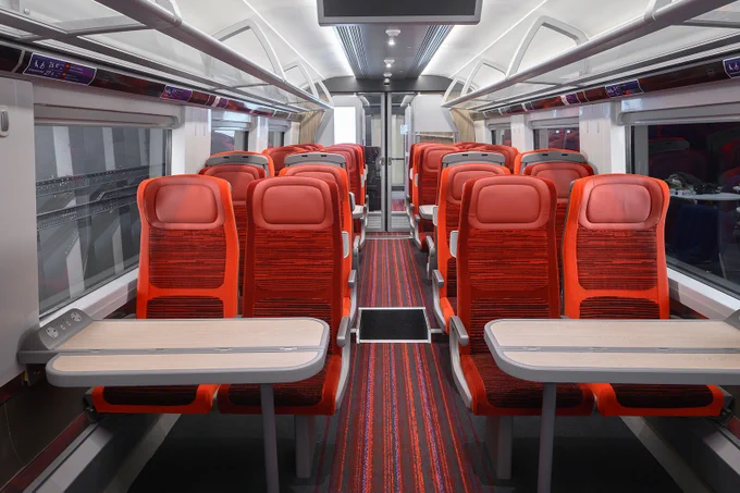 A photograph of a Standard coach on the Class 897 fleet featuring our prime red seats.