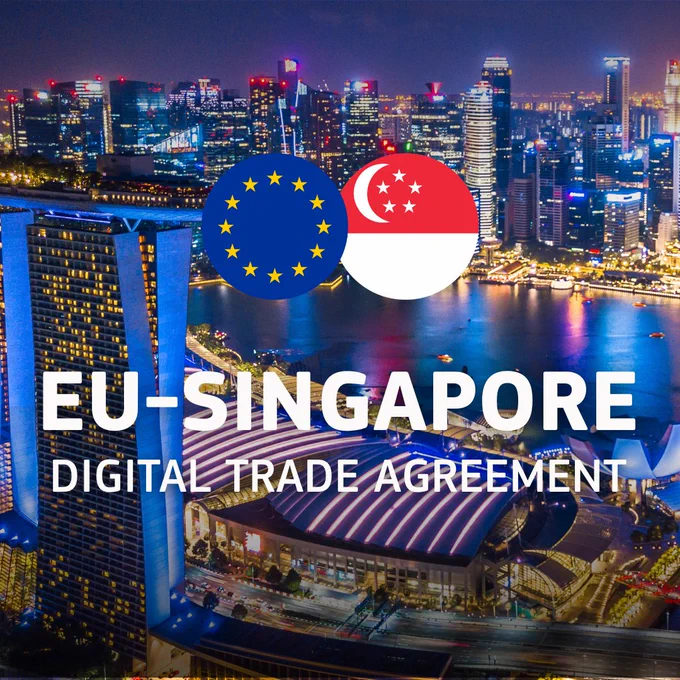 An aerial nighttime view of the Singapore skyline featuring the Marina Bay Sands hotel and brightly lit skyscrapers reflected in the water. Overlaid on the center of the image are the flags of the European Union and Singapore side-by-side. Large white text at the bottom reads, "EU-SINGAPORE DIGITAL TRADE AGREEMENT."