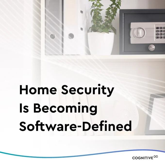 Image: Living room shelf with various decorative items including a wall safe
Text: Home Security Is Becoming Software-Defined
