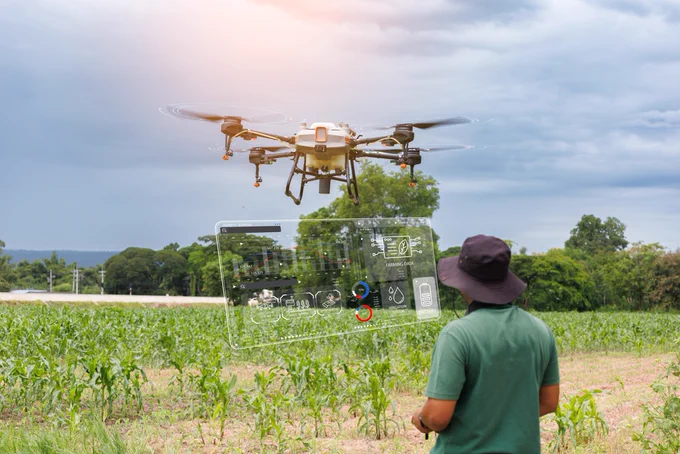 Farmers use modern technology—such as drones—to help increase efficiency in farming and reduce costs. Stock photo. 