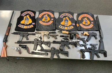 Photo from press release. Firearms (including machine guns and a short-barreled rifle), firearms parts (including a silencer and high-capacity drum magazines), and other items seized from Singh’s 
vehicle and residence on June 6, 2025.
