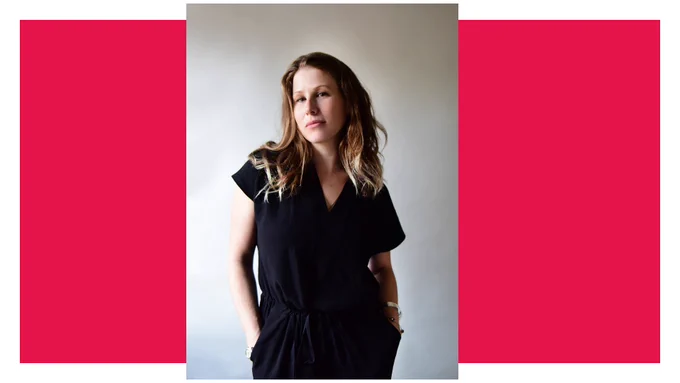 Caroline Criado Perez looks at the camera wearing a dark jumpsuit, with her hands in her pockets