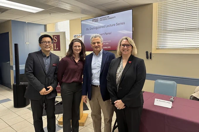 Four people standing in a room. From left are Professor Zhe He, director of the Institute for Successful Longevity at Florida State University; Professor Dawn Carr, director of the Claude Pepper Center; Kenneth Langa, Cyrus Sturgis Professor of Medicine at the University of Michigan; and FSU College of Nursing Associate Professor Lucinda Graven.