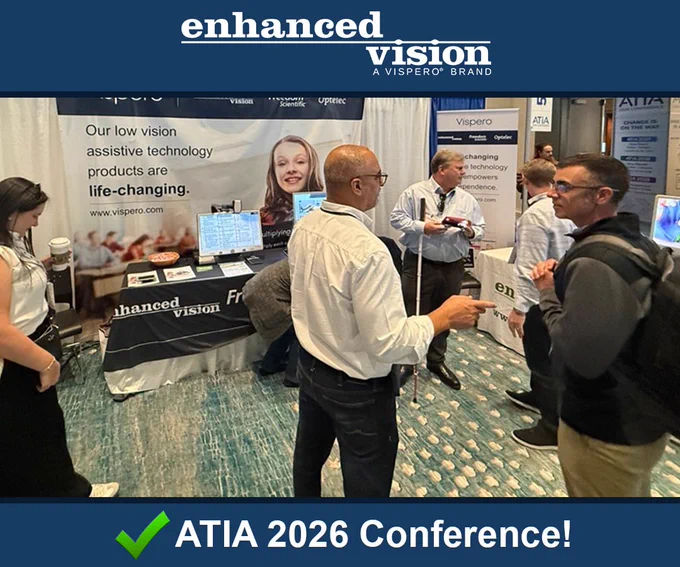 Picture description: 1. Dave and Matt standing in the booth speaking with attendees, electronic video magnifiers and text-to-speech devices being displayed on tables in the background.