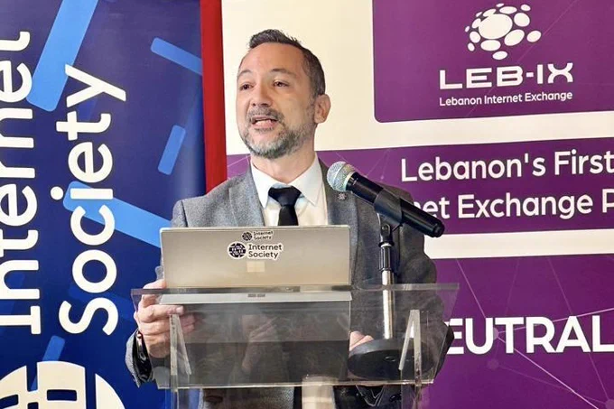 A man stands at a podium and speaks at a Lebanon Chapter event
