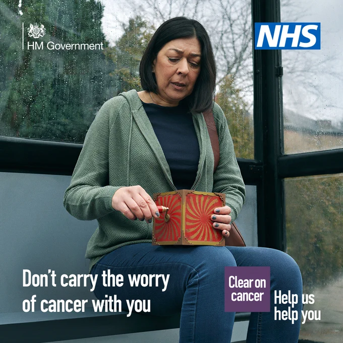Person sitting on a bench holding a red patterned purse, promoting cancer awareness with NHS and HM Government logos visible.