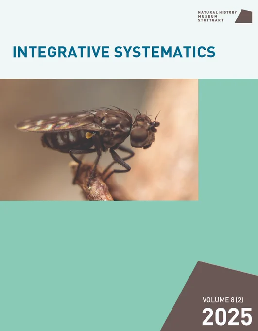 The cover of Vol. 8 (2) of Integrative Systematics, depicting a tiny shore fly in the genus Scatophila, photographed whilst perched on vegetation. The fly has characteristic dark wings with lighter spots