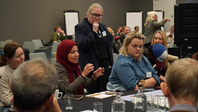 Table of attendees engaged in discussion