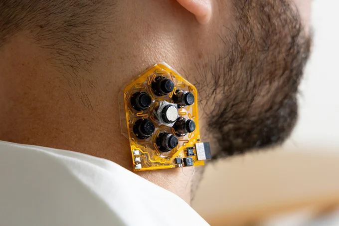 A small patch of haptic actuators worn on the side of Matt Flavin's neck. Paired with a smartphone, the actuators can help people with vision loss navigate their environment.