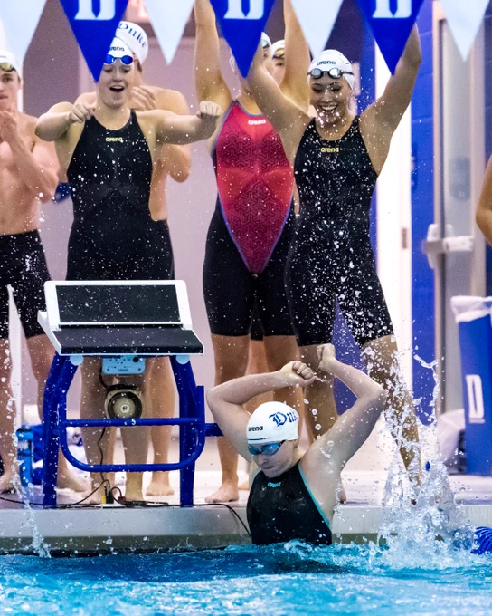Celebration photo of Duke women's swimmers after winning a relay race