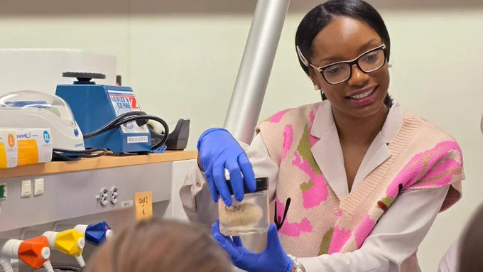 BCS research scholar Zadriana Smith shows a group of middle schoolers what an actual research brain looks like. 