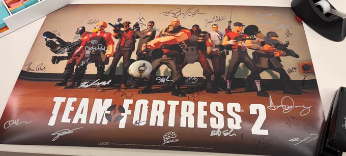 A Team Fortress 2 poster with signatures on it.