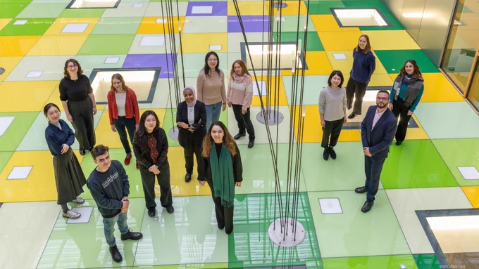 A group of recent graduates who are taking part in the PCT Fellowship Program at the World Intellectual Property Organization are pictured standing together in the workplace.