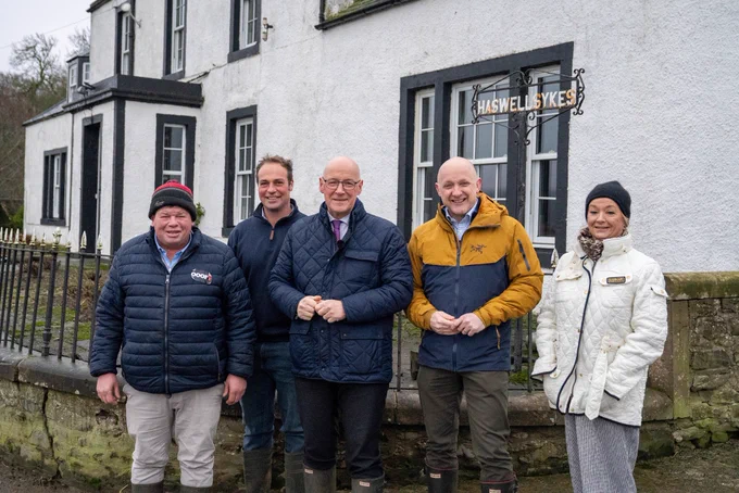 First Minister John Swinney and SNP candidate Calum Kerr meets local farmers in Peebles.