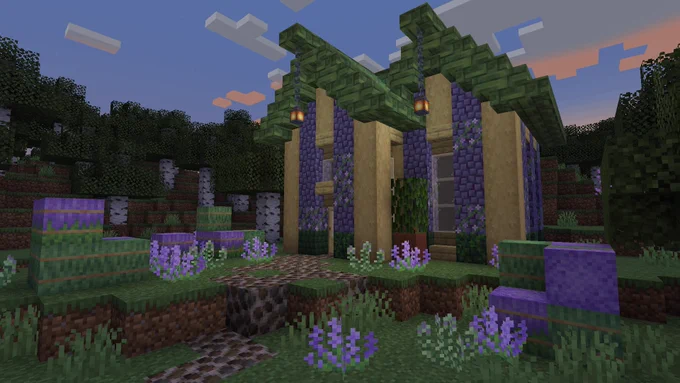 A lavender and birch house with a green trimming for the roof housed within a Birch Forest.
