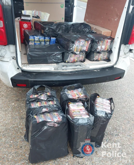 An image of black bin liners filled with tobacco at the back of a van with its rear doors open