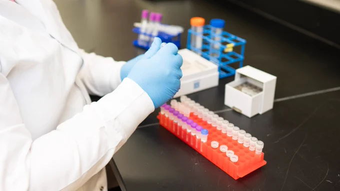 Scientist in a lab working wiht test tubes