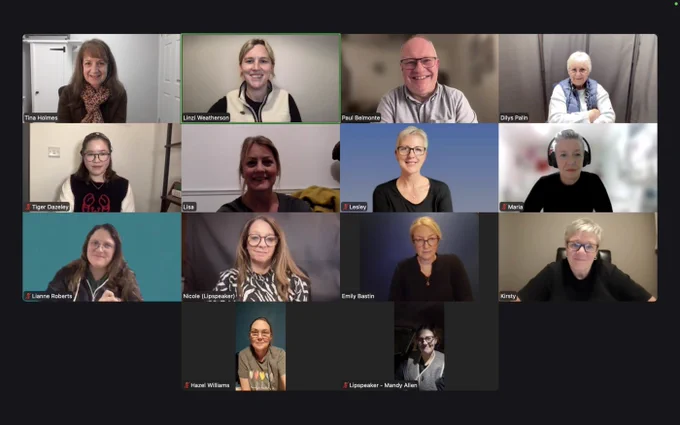 A screenshot of a zoom meeting. There are 14 participants all posing for a picture.