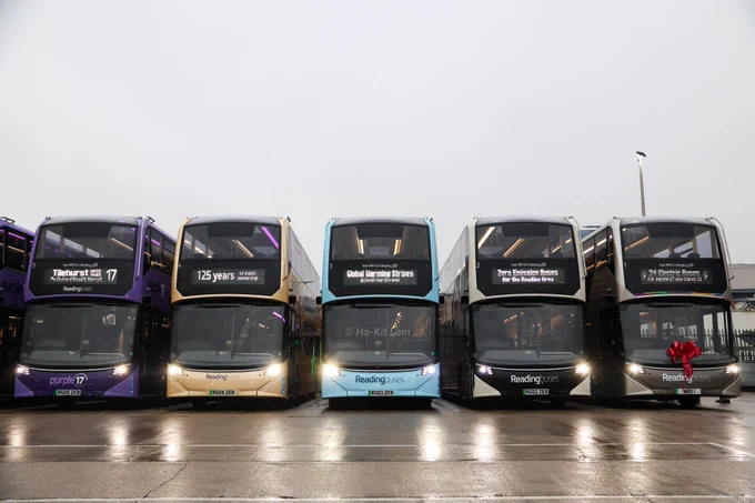 Five of the Alexander Dennis Enviro400EV lined up at Great Knolly Street garage. From right to left, buses are numbered 1 to 5 with private plates RG(number)ZEB except for number 1 which has plate MRD 1. The five buses pictured are in differernt colours, 1 is in grey, 2 is in black and white, 3 is in light blue representing climate streets, 4 is in gold celebrating 125 years of public ownership and 5 is in purple. 