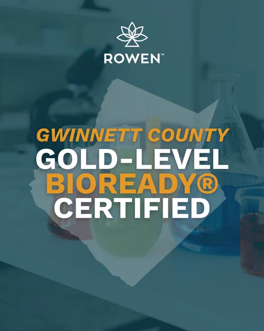 A graphic featuring laboratory glassware filled with colorful liquids, overlaid with the outline of Gwinnett County, Georgia. The Rowen logo appears at the top, and bold text reads: “GWINNETT COUNTY GOLD‑LEVEL BIOREADY® CERTIFIED.”