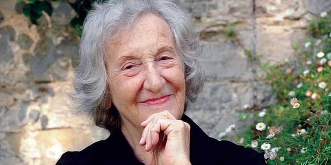 Composer Thea Musgrave, in a garden wearing a black shirt.