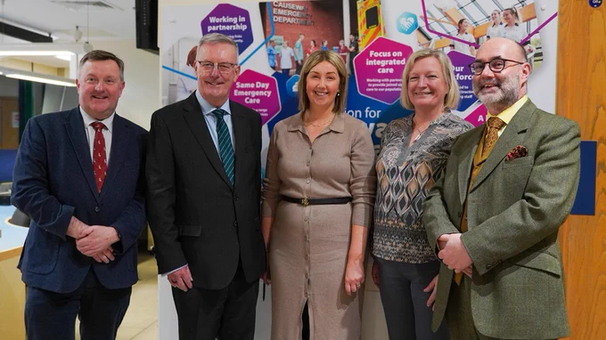 Staff pictured with Health Minister Mike Nesbitt. They are pictured in front of a wall graphic depicting the 'vision' for the Causeway Hospital