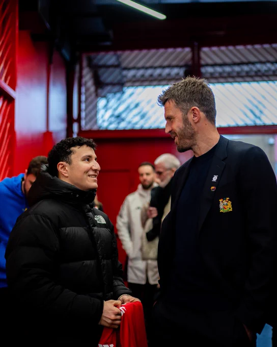 Michael Carrick and Isack Hadjar meet post-match.