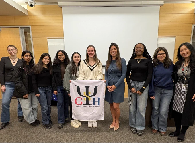 Group photo of members of Psych Society, faculty, and invited speaker standing together after the event.