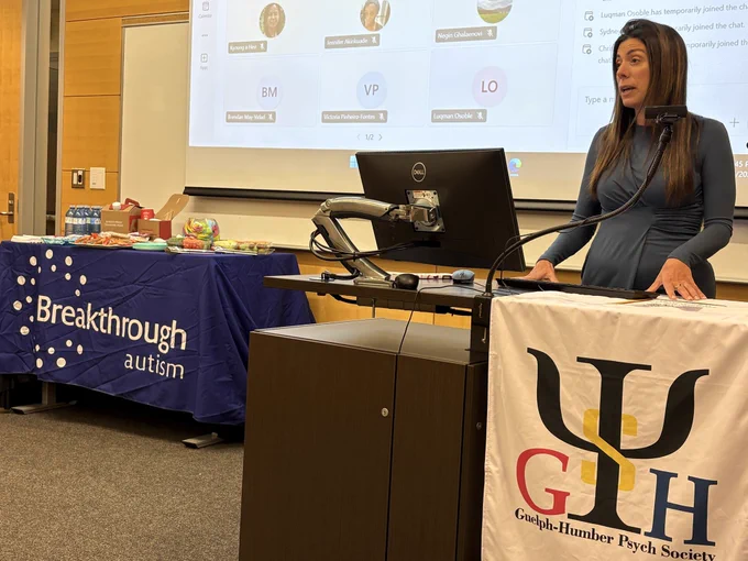 Invited speaker addressing an audience of students during the Q&A session.