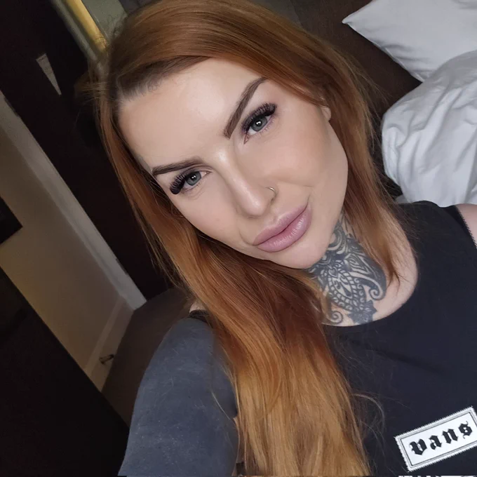 Selfie of Kirsti with a vans vest on and her make up done in a hotel room