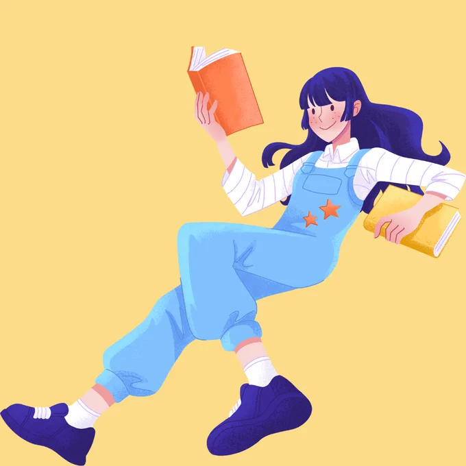 A young person in blue overalls reads an orange book while holding a yellow book in the other hand. 