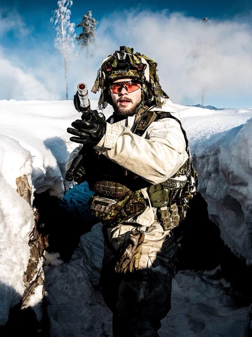 An Estonian Army soldier looks back at advancing British Army troops during a simulated attack near Tapa, Estonia.