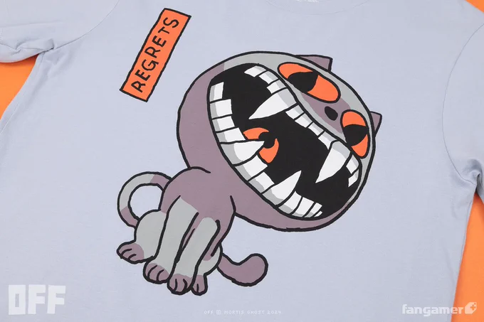 A photo of the front of the Herald of Regrets shirt—the unisex sizes are a pale blue, with a blue-gray illustration of the Judge, his mouth open and his eyes and throat red. The word "REGRETS" is hand-lettered in a red box near the Judge's face. 