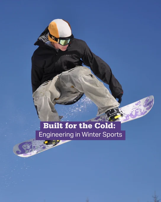 Snowboarder in mid-air wearing a black jacket and beige pants against a clear blue sky.